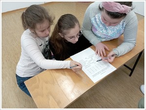 trzy dziewczynki rozwiązują test