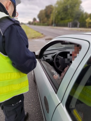 policjant prowadzi kontrolę drogową