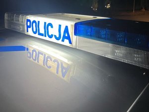 policyjna belka radiowozu podświetlony napis policja w porze nocnej